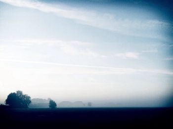 Scenic view of field against cloudy sky