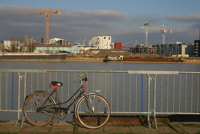 Bicycle parked by railing