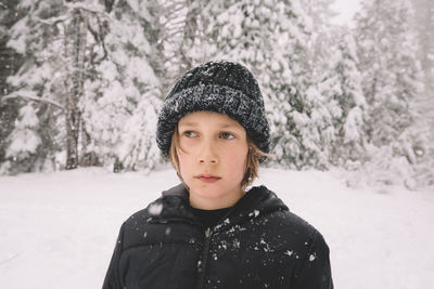 Portrait of man standing in snow