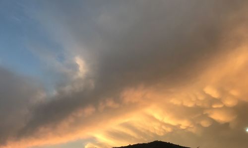 Low angle view of dramatic sky during sunset