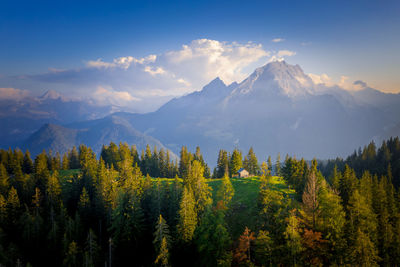 Aerial photo of a mountain hut surrounded by colorful fall foliage, berchtesgaden, bavaria, germany.