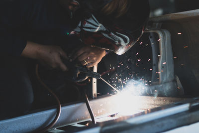 Close-up of man working at workshop