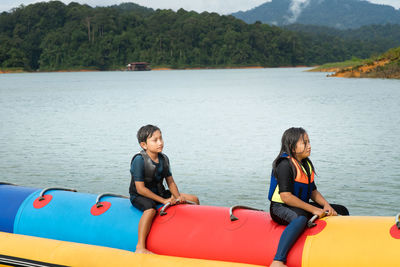 Friends on boat in lake