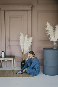 Young beautiful woman posing against the background of the interior