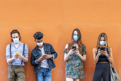 Group of people standing against wall