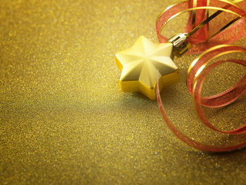 Close-up of christmas decoration on golden table