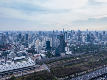 High angle view of modern buildings in city against sky