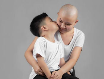 Mother and daughter against white background