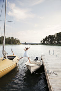 Girl jumping from boat into boat