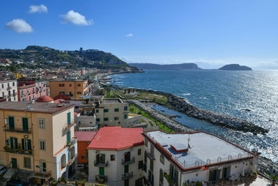 High angle view of townscape by sea against clear sky