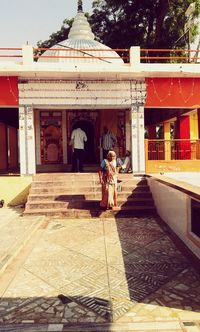 Woman statue outside temple against sky