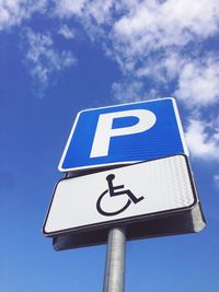 Low angle view of road sign against sky