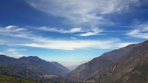 Scenic view of mountains against blue sky