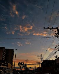 Low angle view of silhouette buildings against sky at sunset