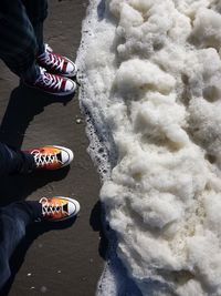 Low section of people standing on land