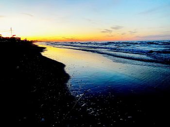 Scenic view of beach against sky during sunset