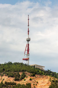 Low angle view of communications tower against sky