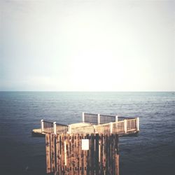 High angle view of diving platform by sea against sky