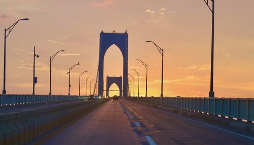 Bridge against sky during sunset in city