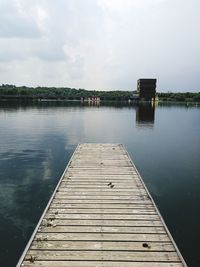 Pier over lake against sky