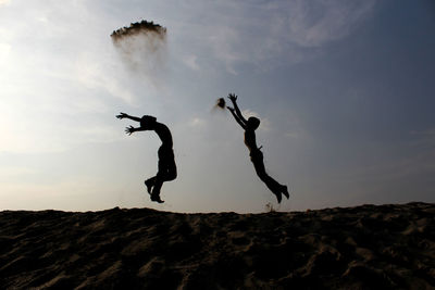 Silhouette of children jumping