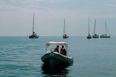 Sailboat sailing on sea against sky