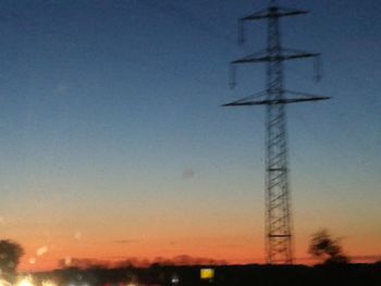 Windmill against clear sky during sunset