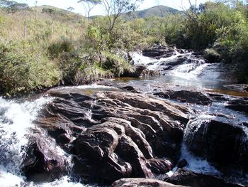 Scenic view of river flowing through rocks