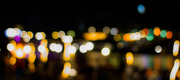 Defocused image of illuminated christmas lights at night