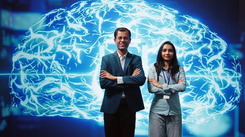 Portrait of business people standing against wall