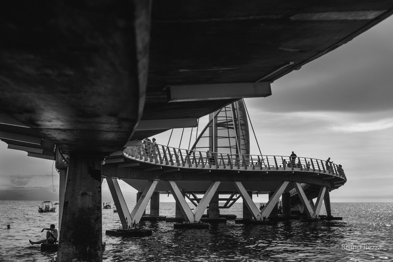 built structure, architecture, sea, water, connection, bridge - man made structure, sky, transportation, engineering, bridge, low angle view, cloud - sky, waterfront, horizon over water, outdoors, no people, day, river, cloud, pier
