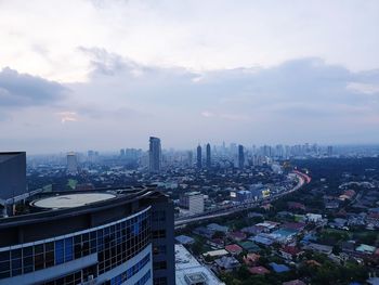 High angle view of buildings in city against sky