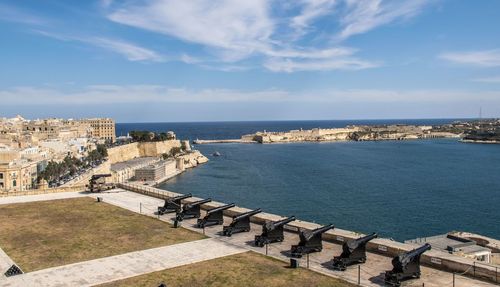 Panoramic view of sea and buildings against sky