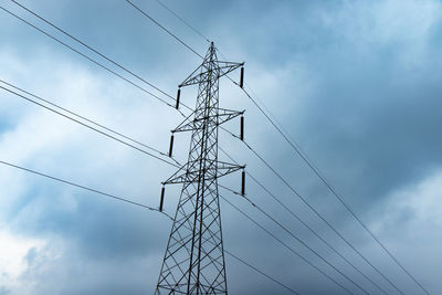 Low angle view of electricity pylon against sky