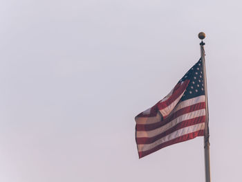 Low angle view of flag against clear sky