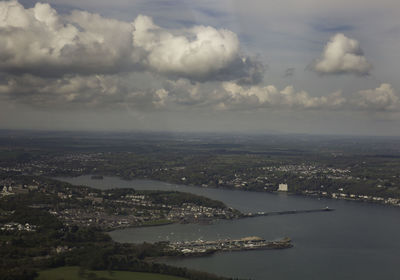 High angle view of cityscape by sea against sky