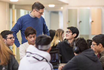 Teacher talking to teenage boys