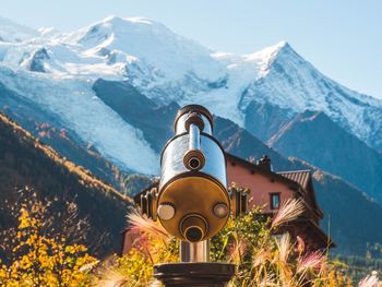 Built structure on snowcapped mountain against sky