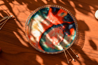 High angle view of a colourful painting in a diy project made with food colouring, milk, detergent