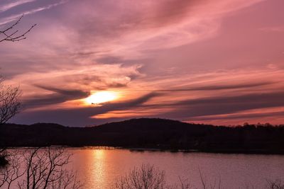 Scenic view of lake against romantic sky at sunset