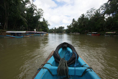 Rear view of man in river against sky