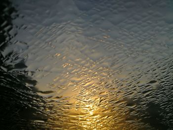 Full frame shot of raindrops on water