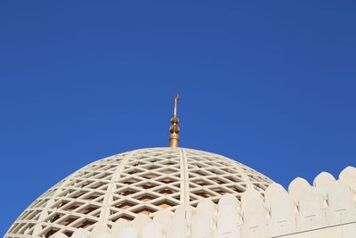 Low angle view of mosque against blue sky