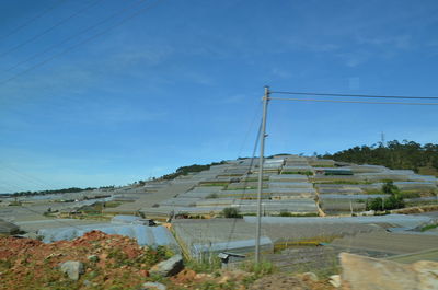 Built structure on land against blue sky