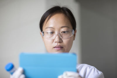 Scientist female with sample and tablet in a lab