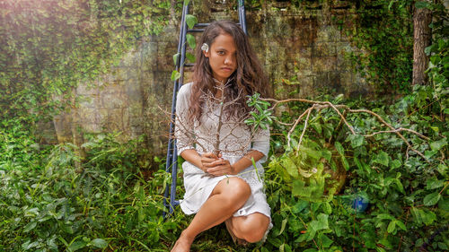 Young woman sitting on grass