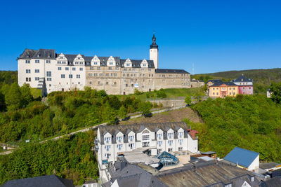 Buildings against clear blue sky