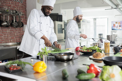 Midsection of scientist working in restaurant