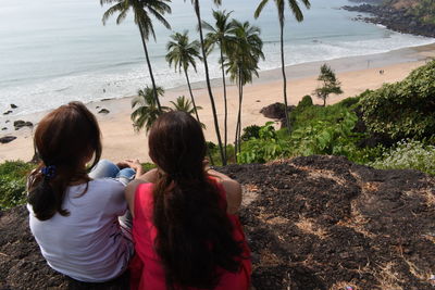 Rear view of women looking at sea