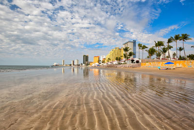 Panoramic view of beach against sky in city